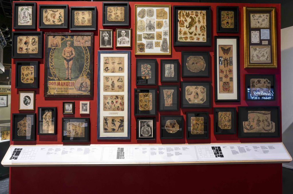 Wall of rare Tattoo flash, part of Tattoo British Tattoo Art Revealed at The National Maritime Museum Cornwall in Falmouth